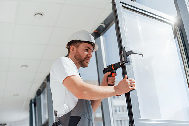 Contractor installing glass hardware