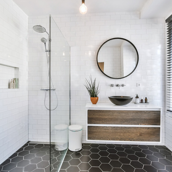 Glass shower with black hardware and vanity