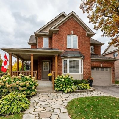 Beautiful brick house with large windows and a well-kept exterior.